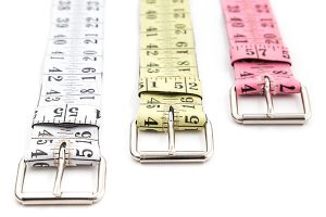 Belts made of upcycled yellow coral pink white black tape measure sewn on cotton base recycling repurposed reclaimed